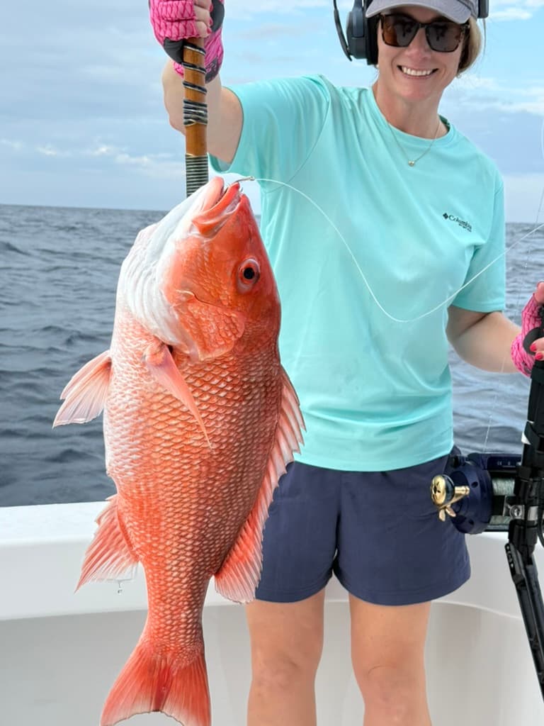 Angler at the rail with a huge red snapper